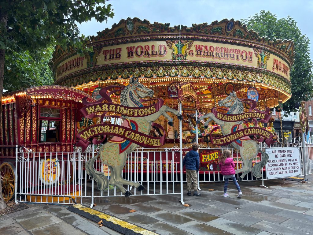 Colourful and intricately decorated antique carousel set up on the streets of York, England.