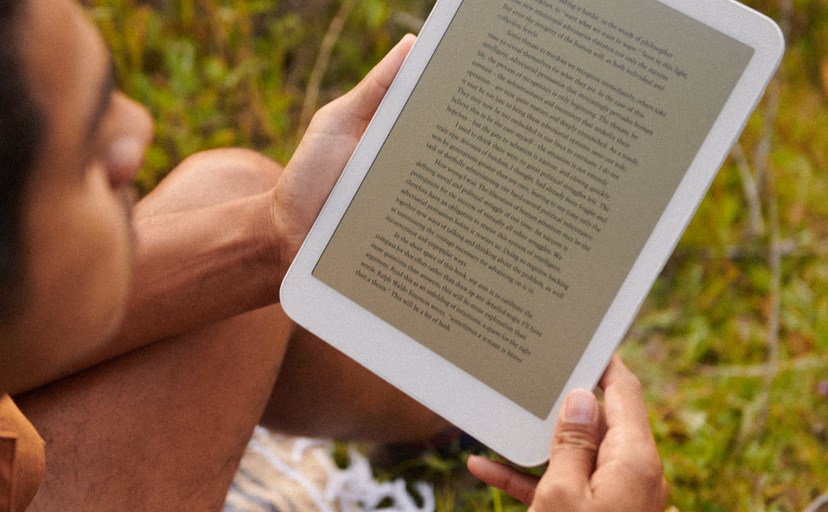 daylight computer tablet in hands outside reading book during day