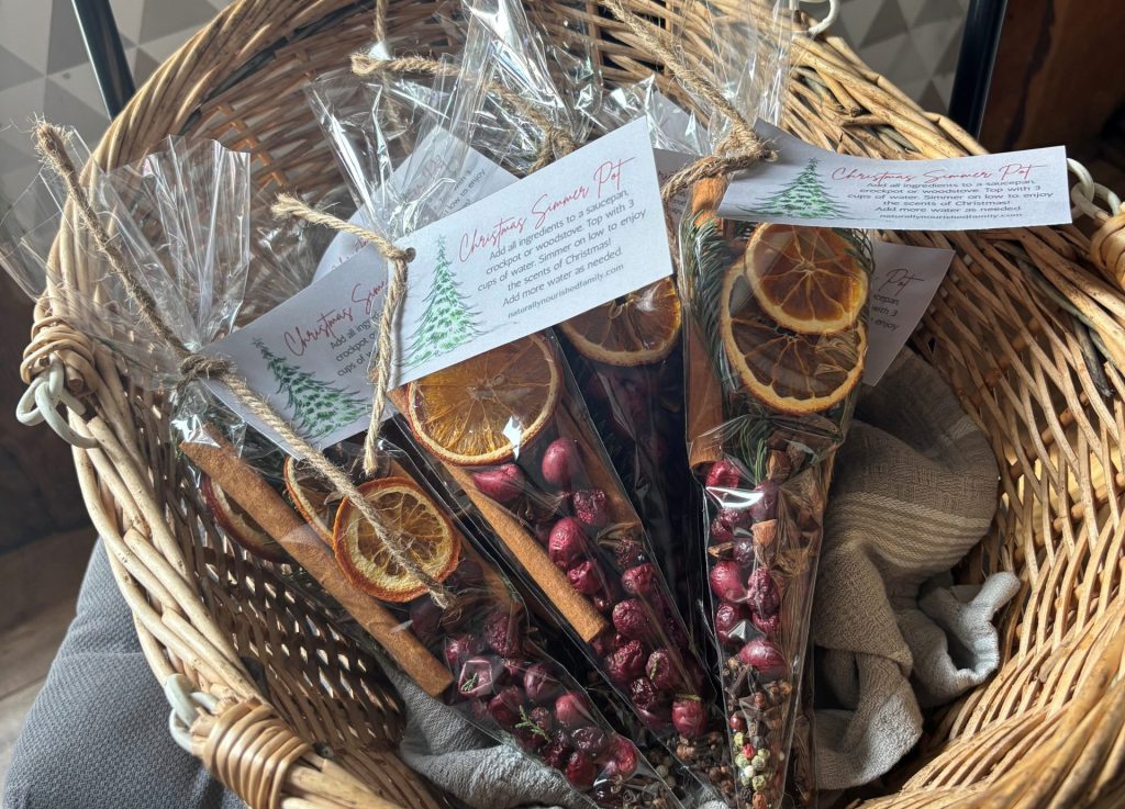 Completed simmer pot bags with gift tags in basket sitting on chair