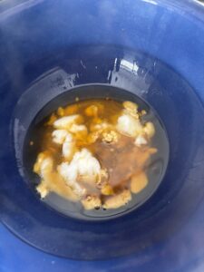 Close up of blue bowl with oils melting for preparation of natural deodorant