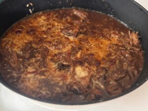 French Onion potroast in dutch oven with gruyere cheese