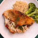 stuffed chicken breast on plate with broccoli and brown rice