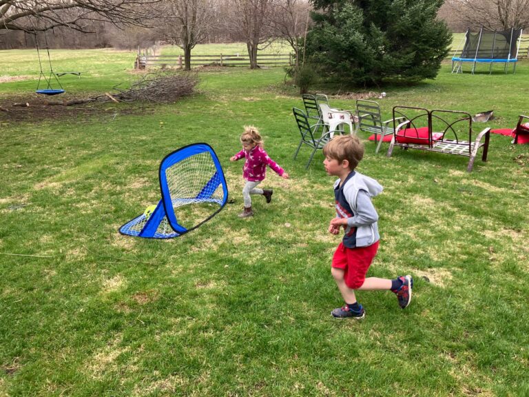 Kids playing in backyard in the springtime