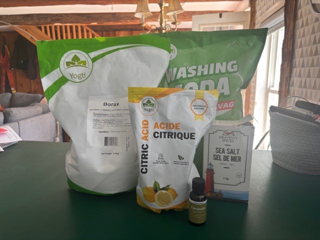 DIY dishwasher detergent ingredients on green countertop in kitchen