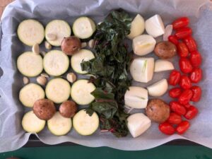 roasting a variety of colourful vegetables that I had in my fridge on a sheet pan covered with parchment paper