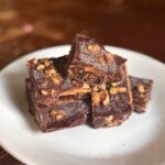 homemade date bark on small white plate on rustic table