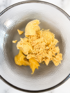 shea butter and cocoa butter in solid form in clear glass bowl