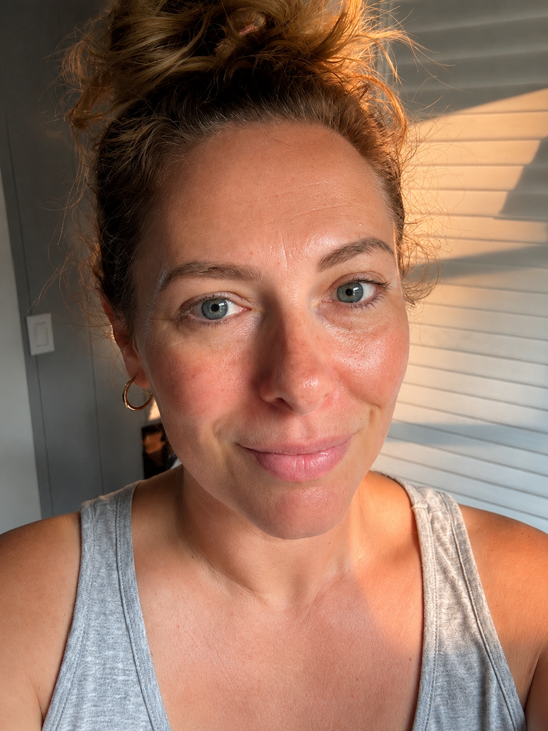 woman with hydrated tanned skin wearing grey tank top